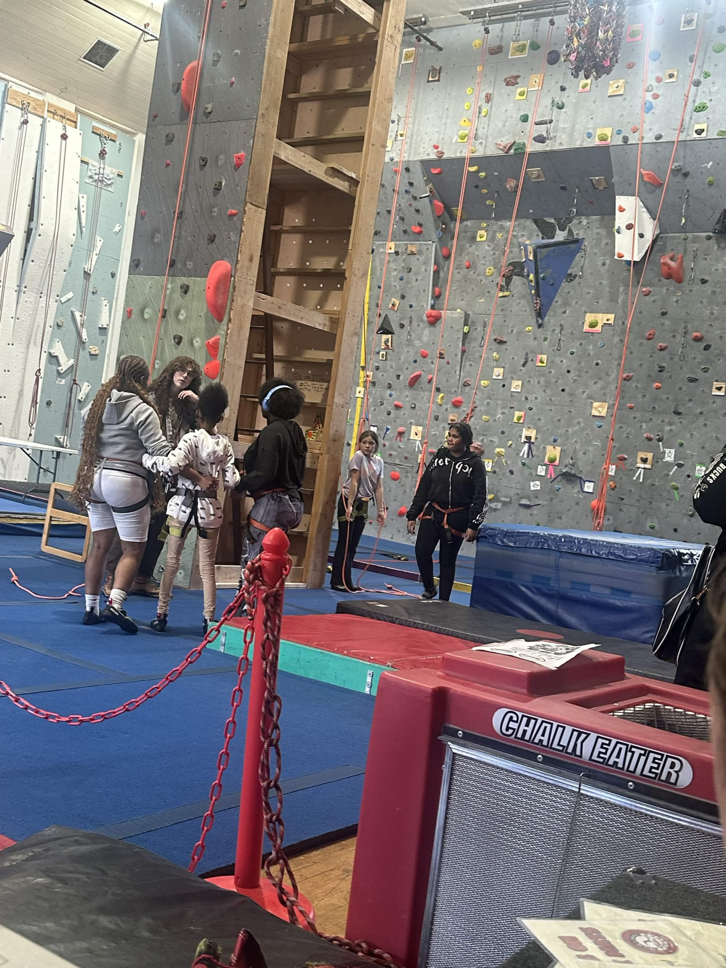 Participants waiting their turn near the climbing wall.